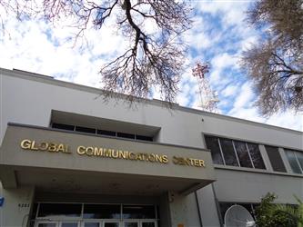The gold text on the Global Communications Center building