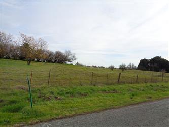 The West 4th and E Property owned by Twin Rivers - A fence next to an empty road