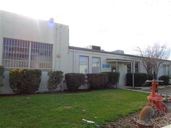 The Raft Property owned by Twin Rivers - The front of a large building, a valve is in a spot in front of the grass